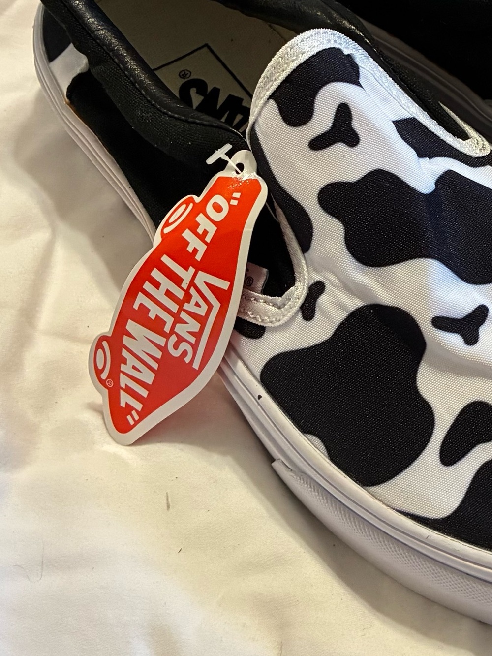Vans Kids Slip-On Sneakers in Black & White Cow Pattern